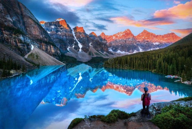 hiker-watching-sun-lit-mountains-summer-sunrise-over-glacier-fed-moraine-lake-banff-canada-enjoying-golden-valley-ten-335108392 (1)